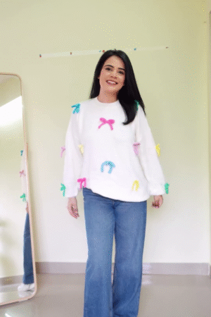Soft White Fleece Pullover Sweatshirt with Multicolor 3D Bow Appliqué Embellishments and Relaxed Balloon Sleeves Paired with Classic Blue Wide-Leg Denim Jeans